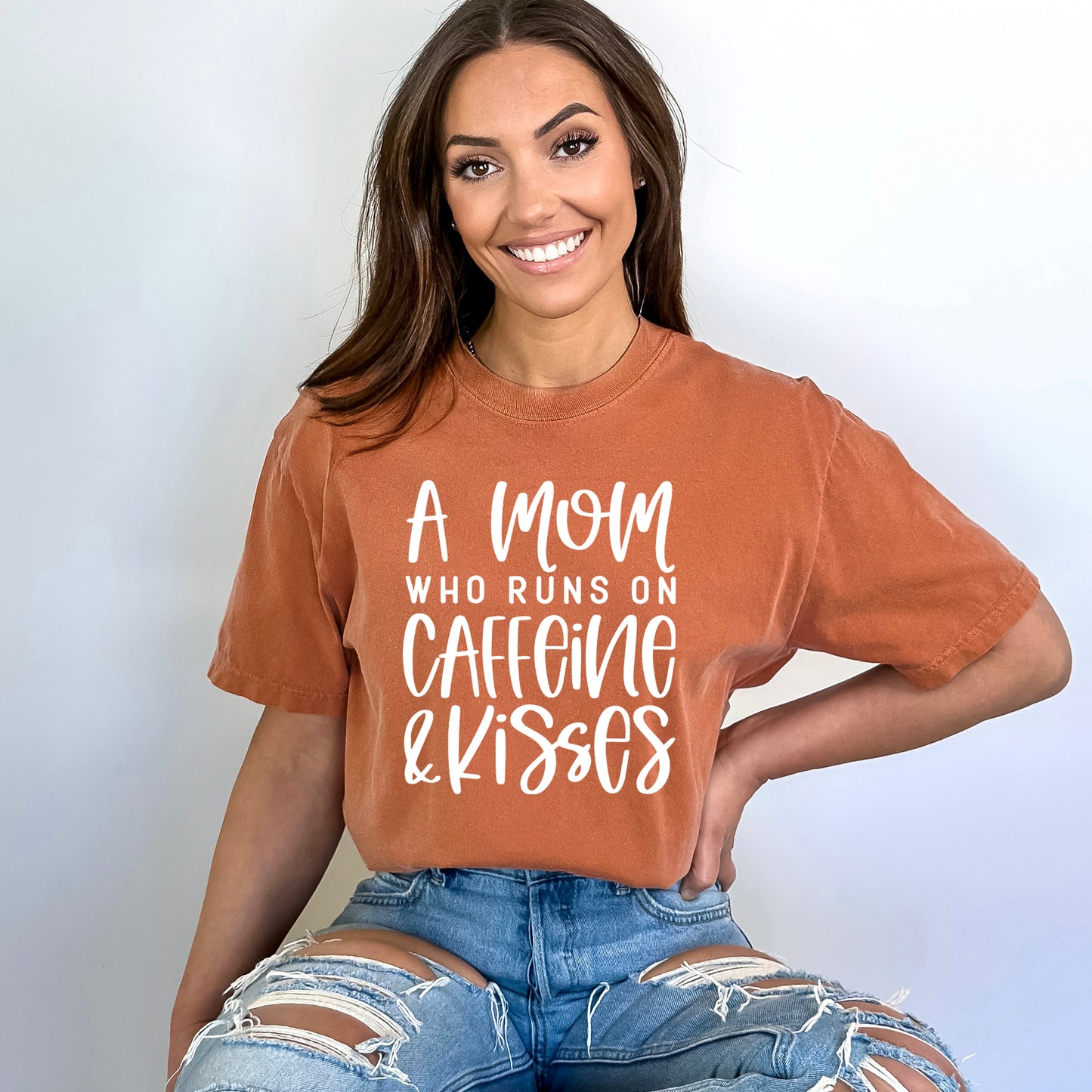 A Mom Who Runs On Caffeine And Kisses | Garment Dyed Short Sleeve Tee