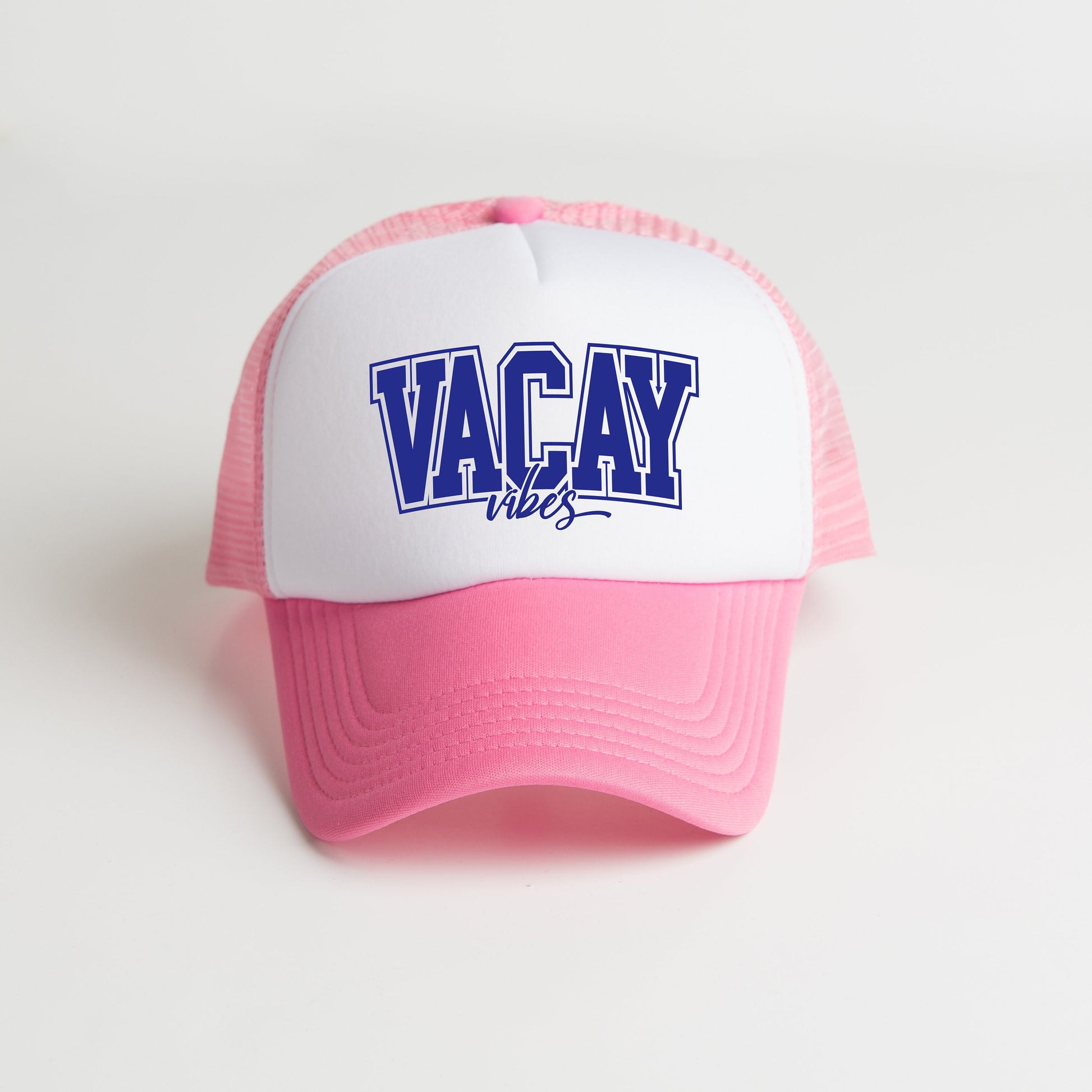 a pink and white hat with the word vacay on it