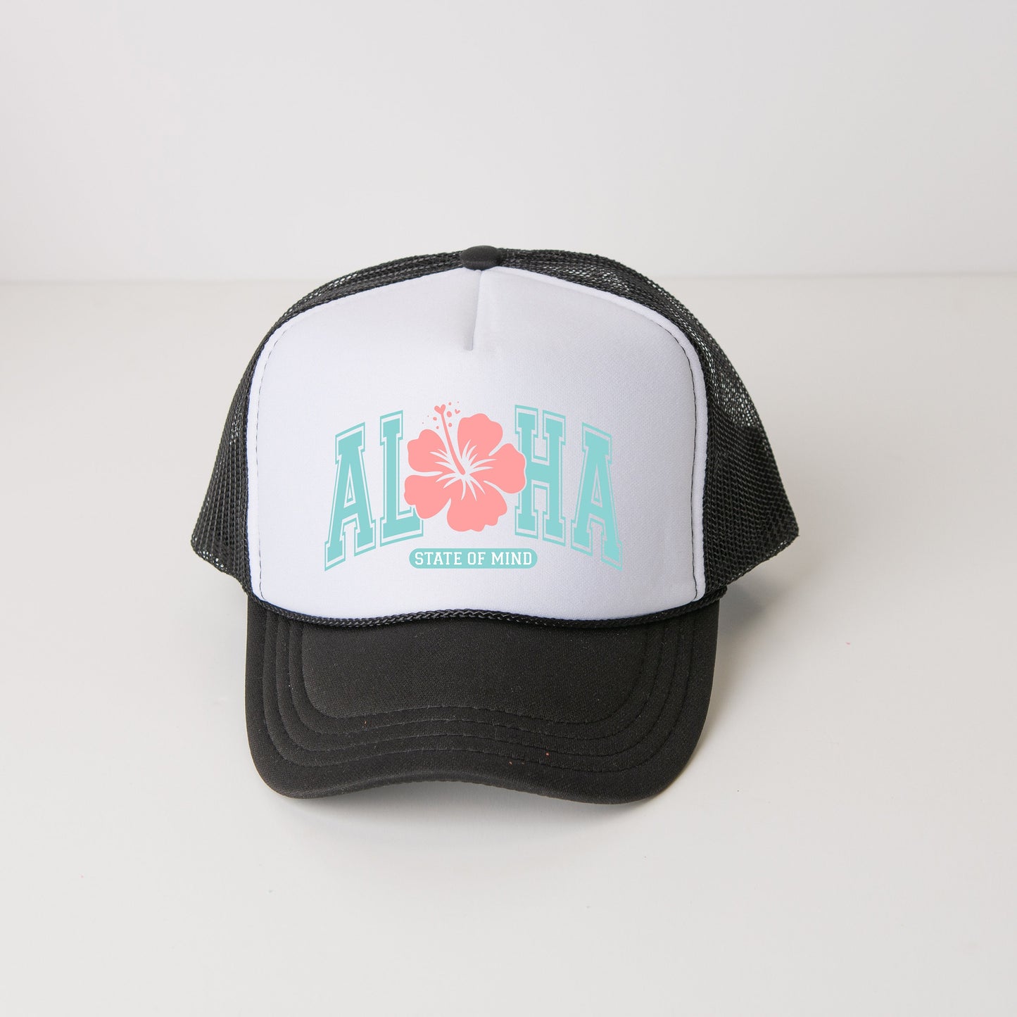 a black and white trucker hat with a flower on it