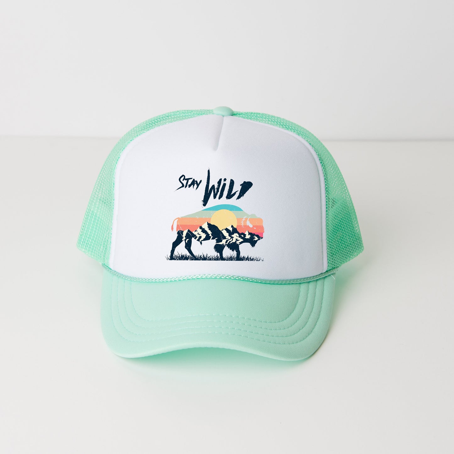 a green and white trucker hat with a picture of a bear