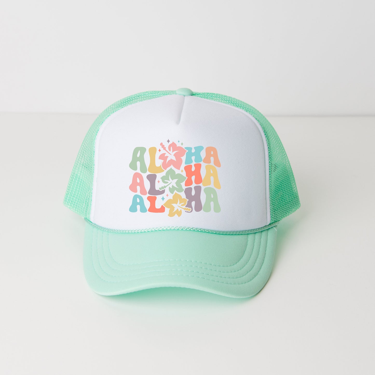 a green and white trucker hat with the words aloha on it