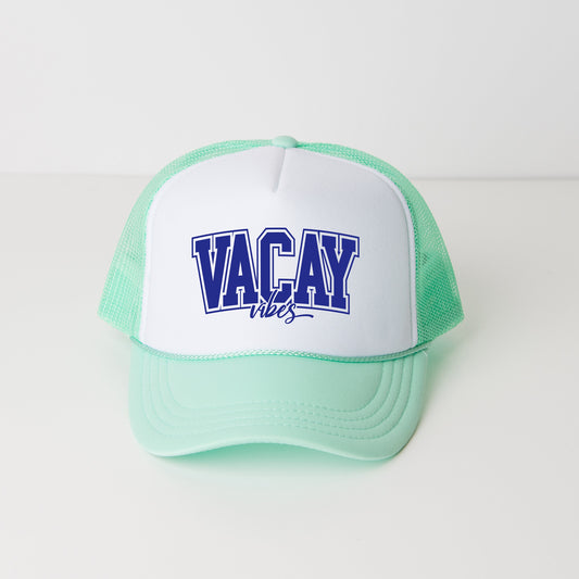 a green and white hat with the word vacay on it