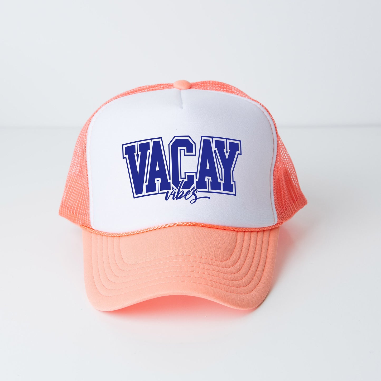a white and orange hat with the words vacay on it