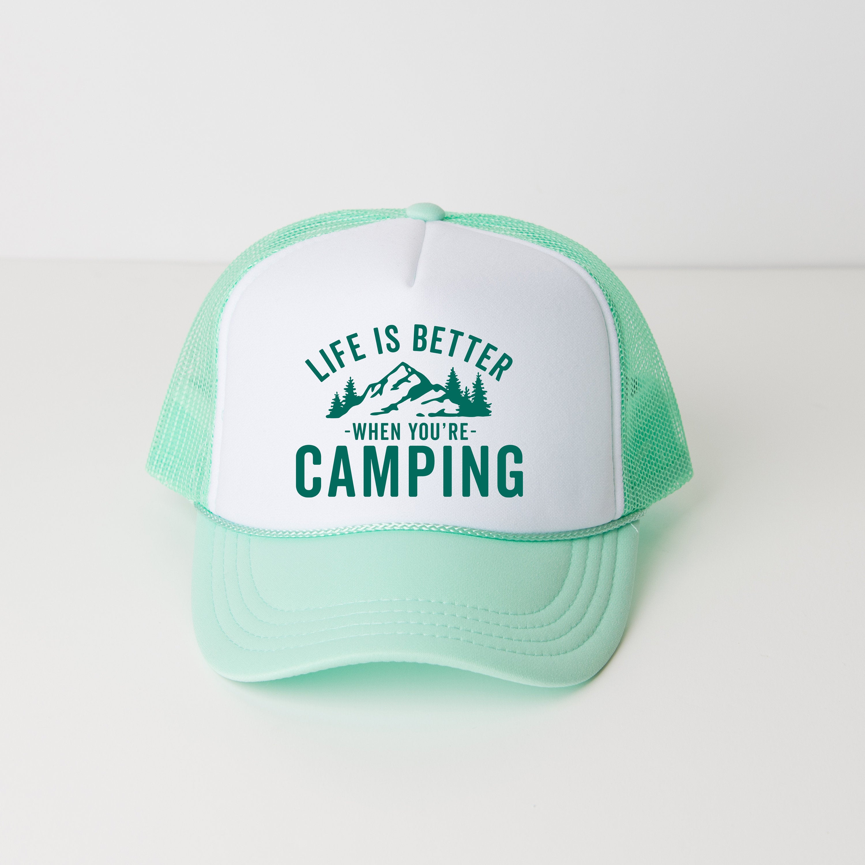a green and white hat that says life is better when you're camping