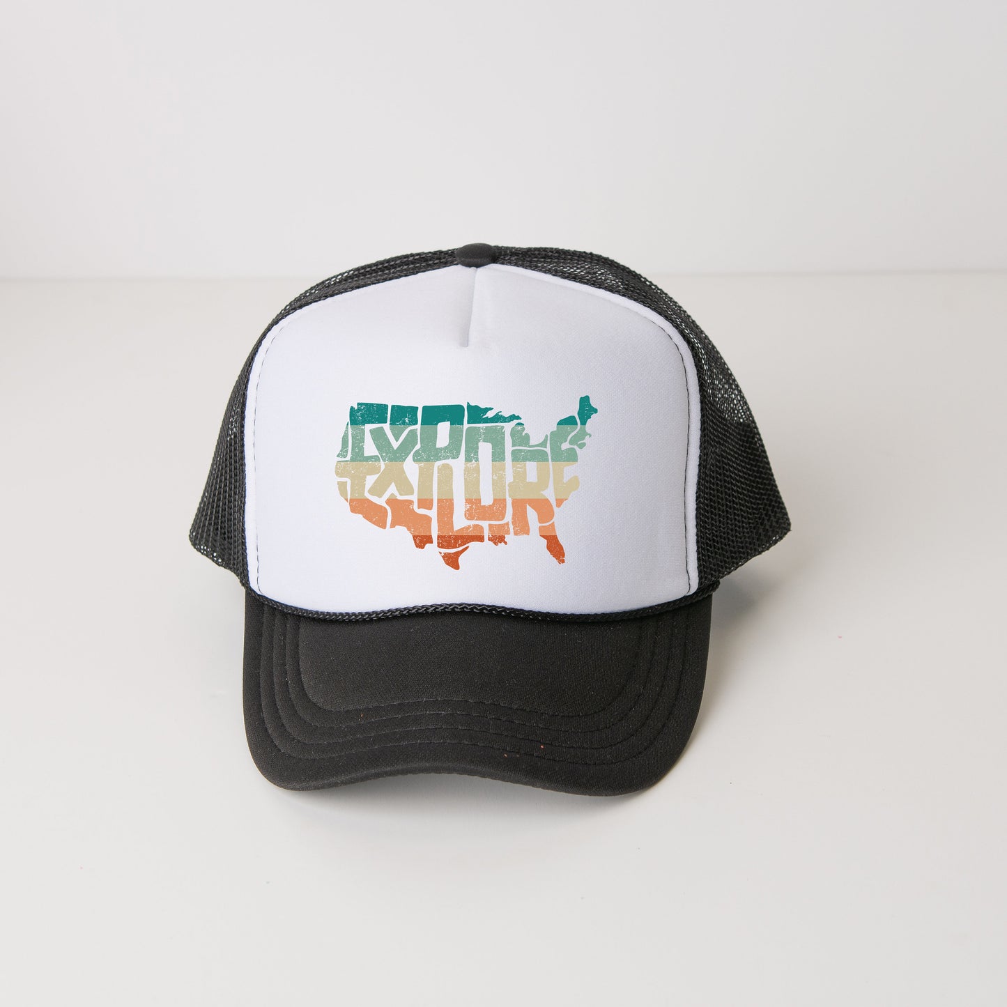 a black and white trucker hat with the word explore written on it