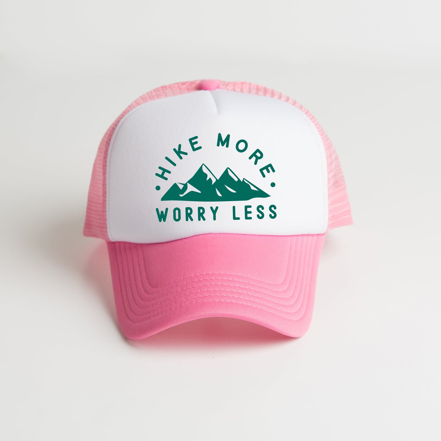 a pink and white trucker hat with the words hike more worry less on it