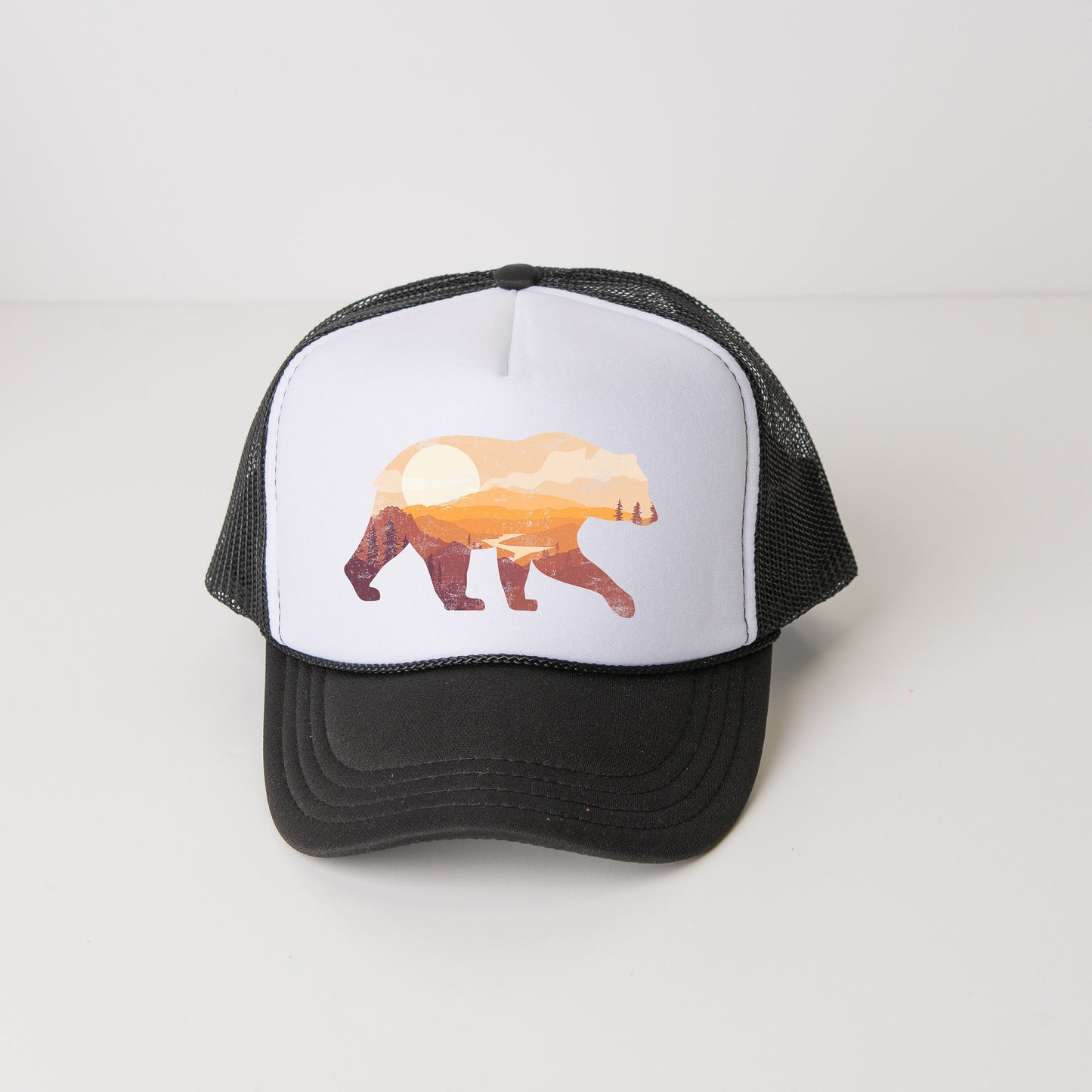 a black and white hat with a bear on it