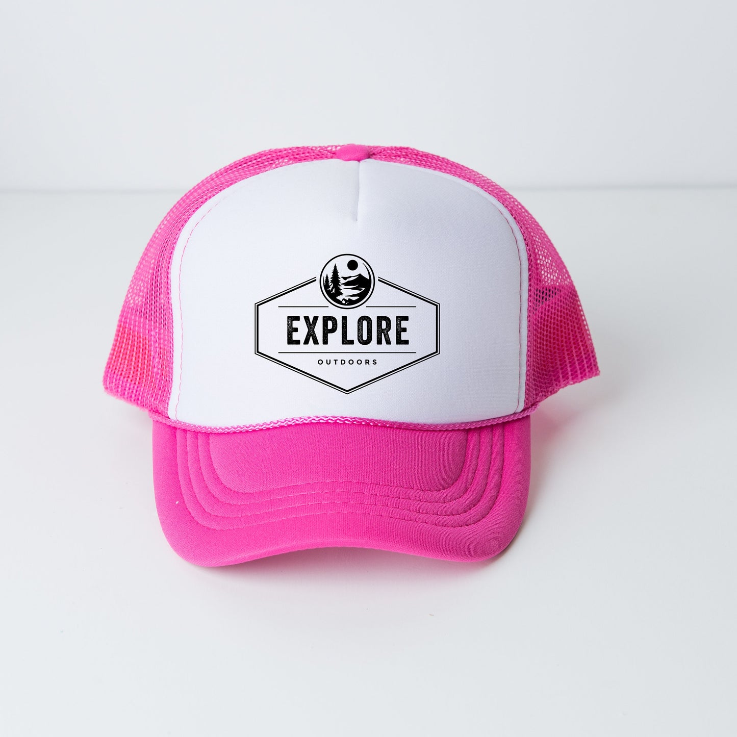 a pink and white trucker hat with the words explore on it