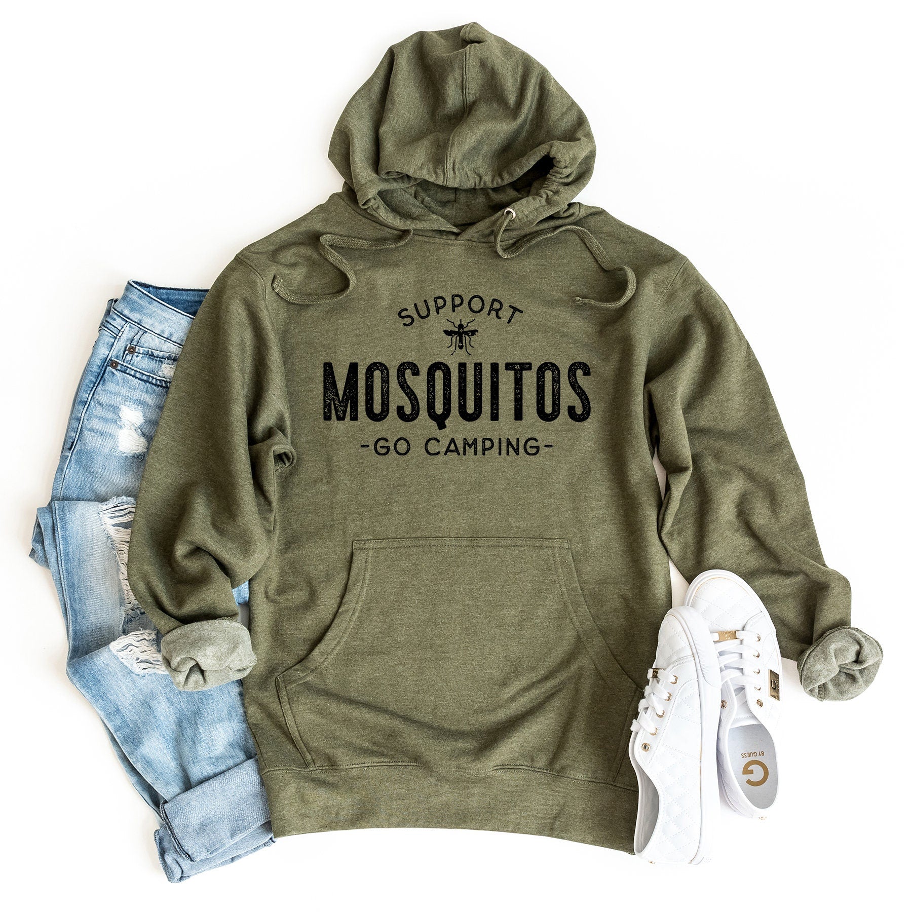 a green hoodie with a pair of ripped jeans and a pair of white sneakers