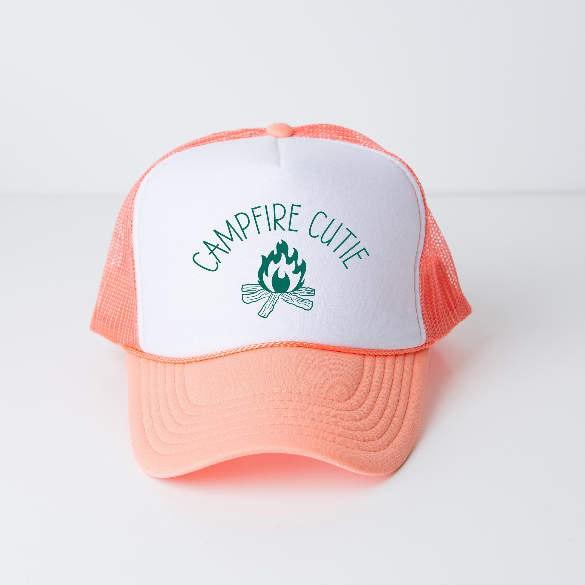 a pink and white trucker hat with a campfire cute logo