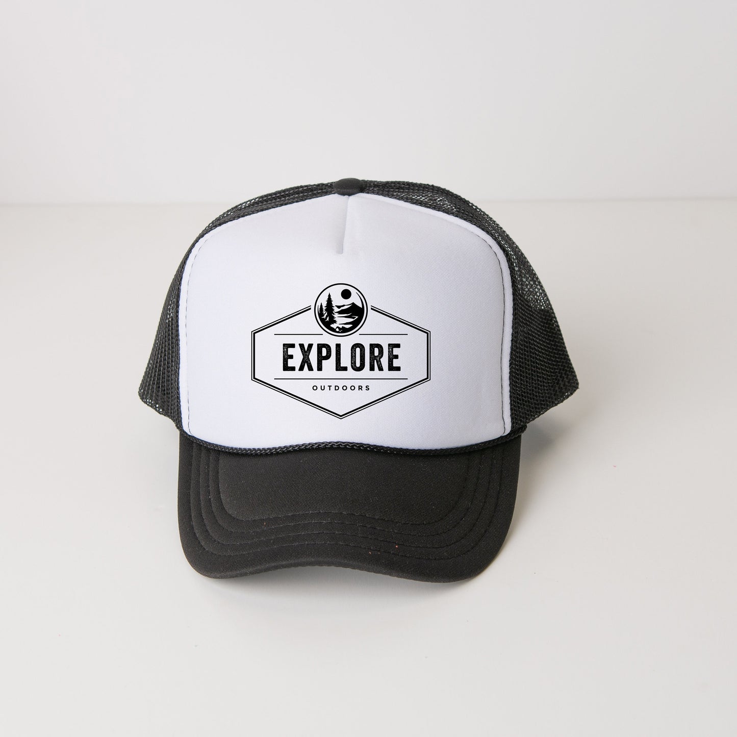a black and white trucker hat with the words explore printed on it