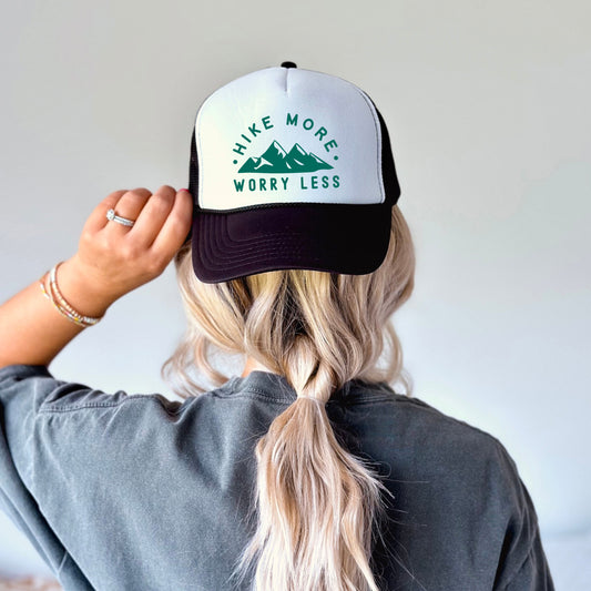 the back of a woman&#39;s head wearing a hat that says hike more worry